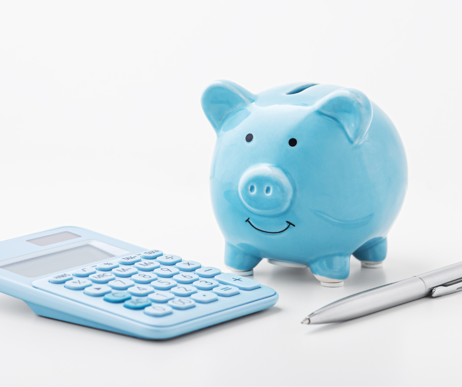 blue piggy banks with pen and calculator