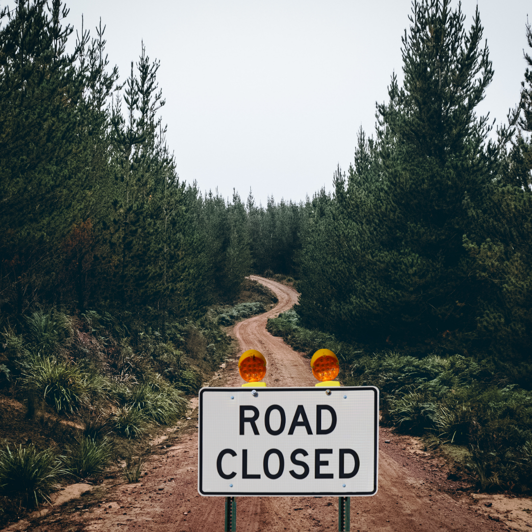 Dirt Road with Road Closed Sign
