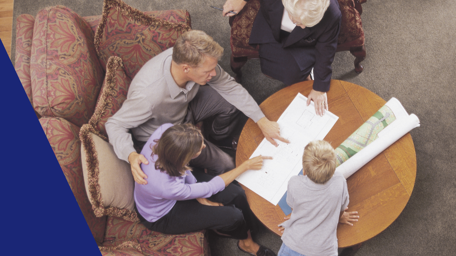 A family of four sitting around a table with a map