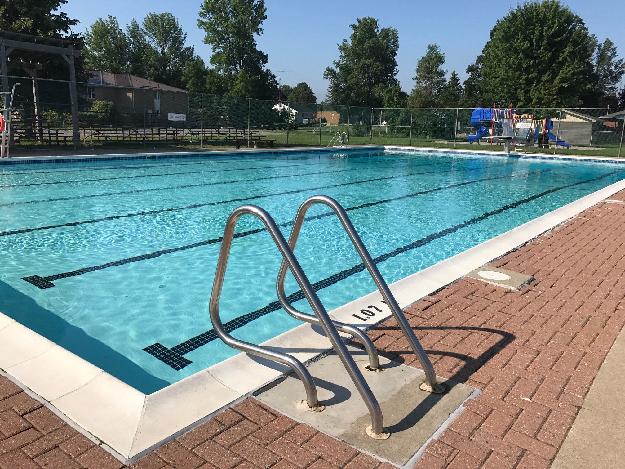 Large inground pool with ladder