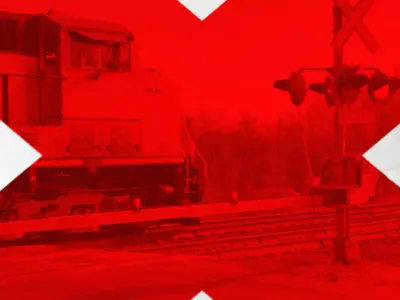 train at railway crossings with large red X over image