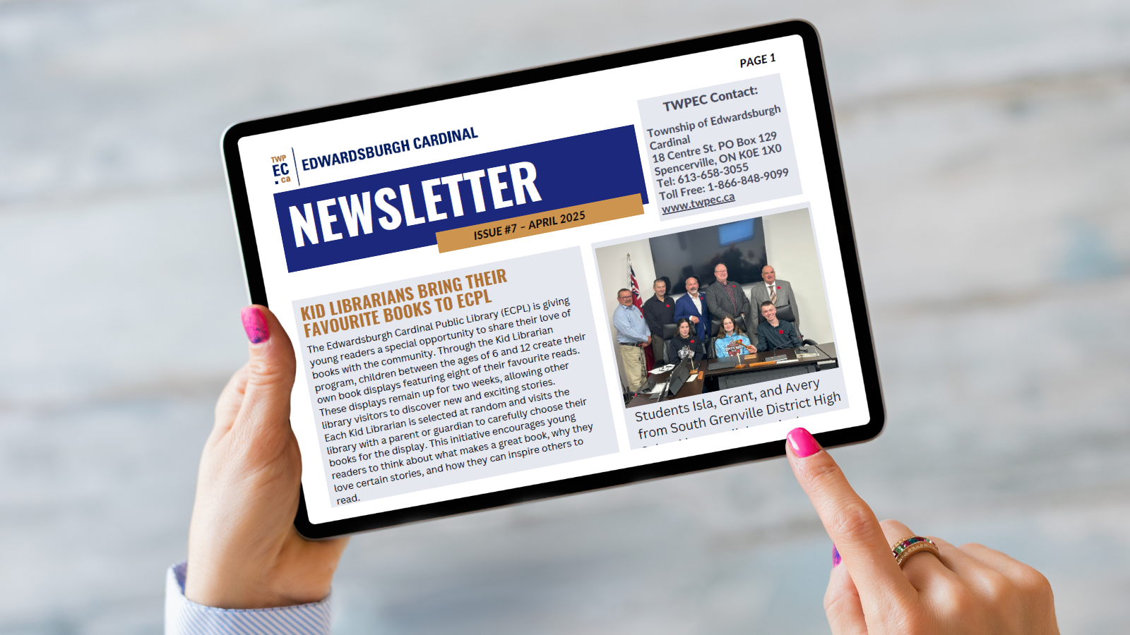 table being held by hands displaying newsletter