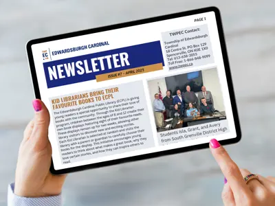 table being held by hands displaying newsletter