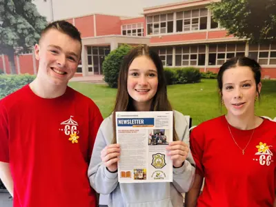 Three high school students holding township