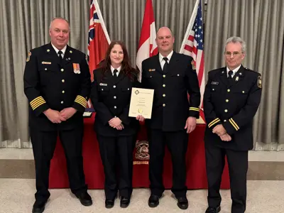Chief Brian Moore with Ann Shorey, who was presented with a certificate for achieving Fire Officer Level One certification, Caption Steve Roberts and Scott Hayes from the Ontario Fire Marshal’s Office.