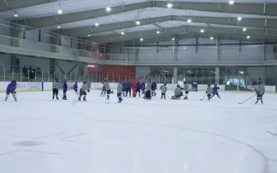 kids practicing hockey at the arena