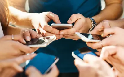 a group of people using cell phones