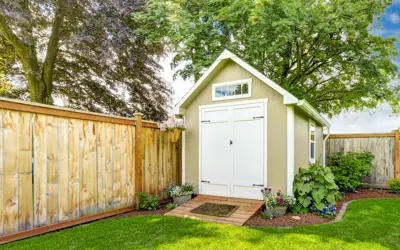 a shed in a landscaped backyard