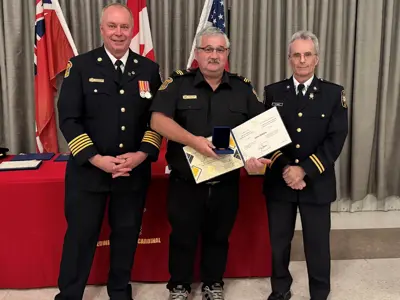 Fire Chief Brian Moore, with John Dobbie, who recognized for recognized for 30-years of service, and Scott Hayes.