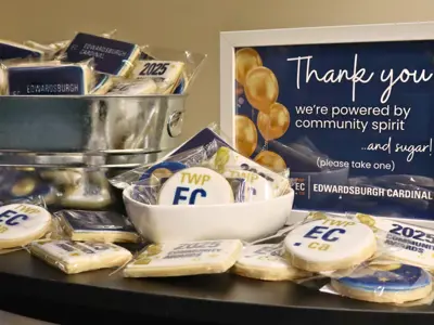 Table with EC branded cookies and a sign thanking attendees.