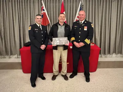 Josh Couture, President of the Edwardsburgh Cardinal Firefighters Association, with Councillor Joe Martelle, who was presented with a special appreciation award for his ongoing support of the Fire Department, and Fire Chief Brian Moore.